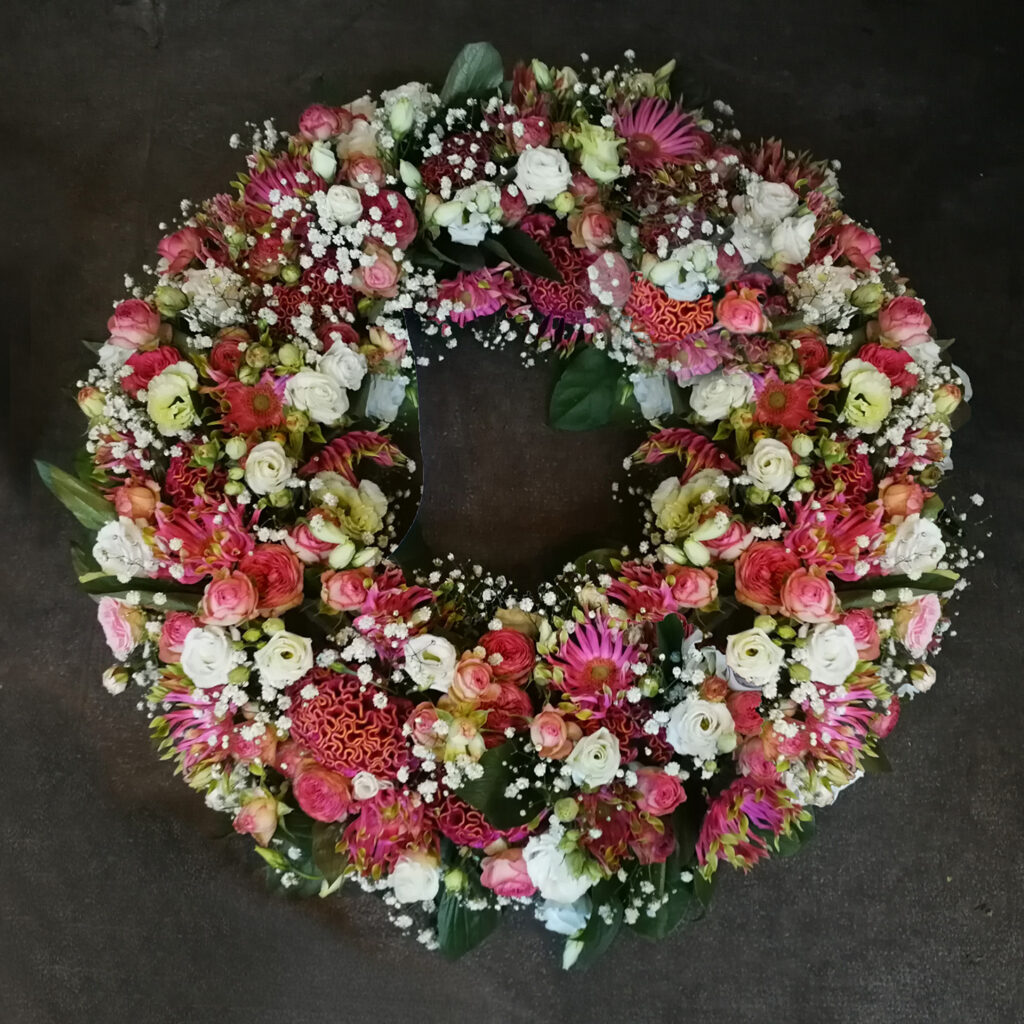 Funeral Flowers, Wreath with coral, red and and dark purplele flowers - roses, lisianthus and special garden flowers