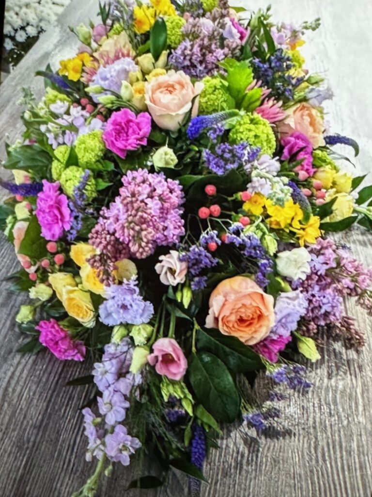 Funeral colorful bouquet with roses and different garden flowers