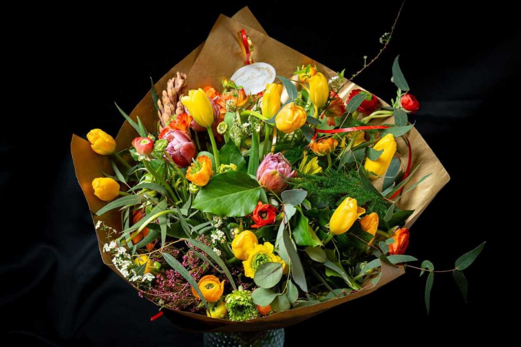 Flower bouquet with spring flowers, tulips, ranunculus and garden flowers