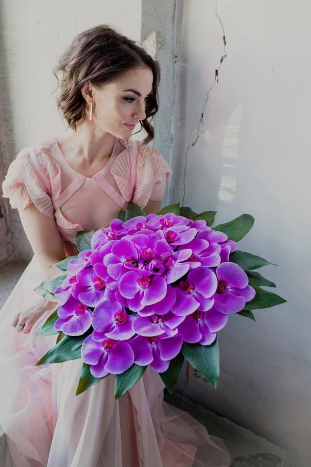 Wedding bouquet with orchids in magenta-purple hue