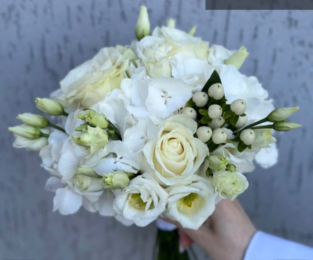 Round classical wedding bouquet with white flowers