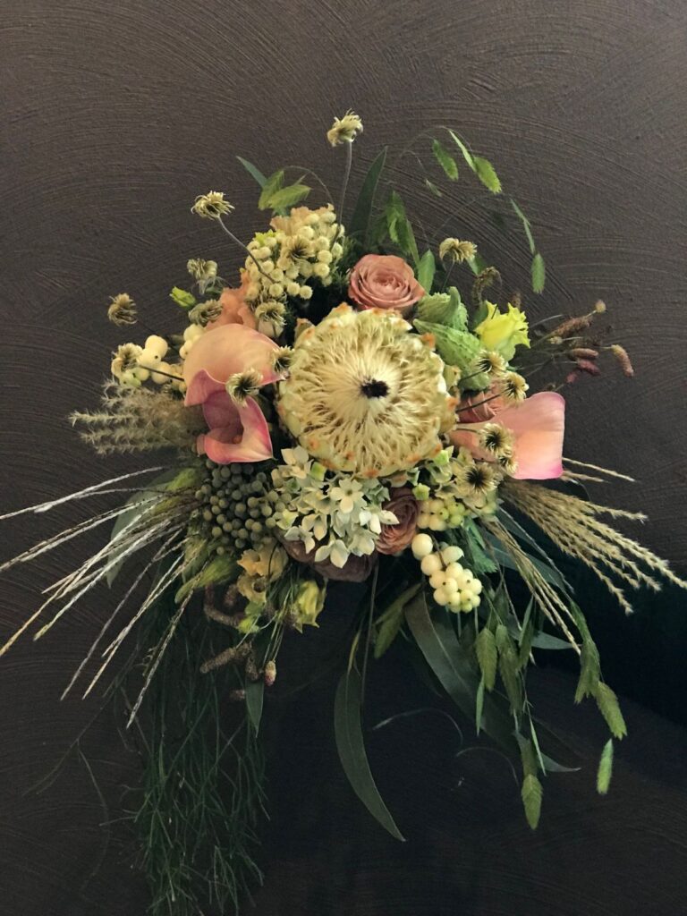 Pastel wedding bouquet with white protea